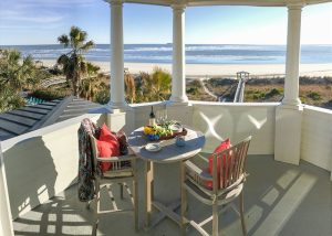 porch with dining and seating overlooking beach on isle of palms