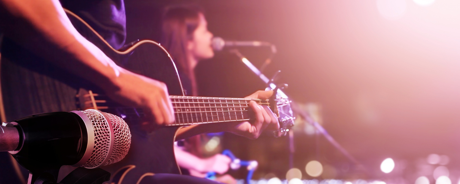 person playing guitar and woman singing