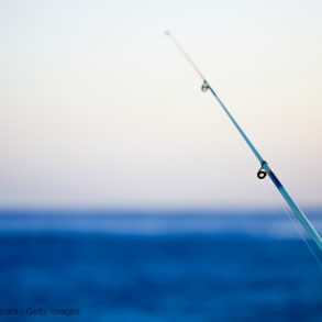 fishing pole in front of the ocean; surf fishing on Isle of Palms