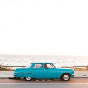 Vintage car driving along the coast