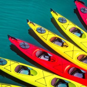 a collection of kayaks on the ocean