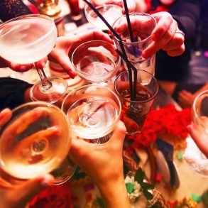 Clinking glasses with alcohol and toasting, party