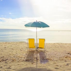 Two chairs on the beach.