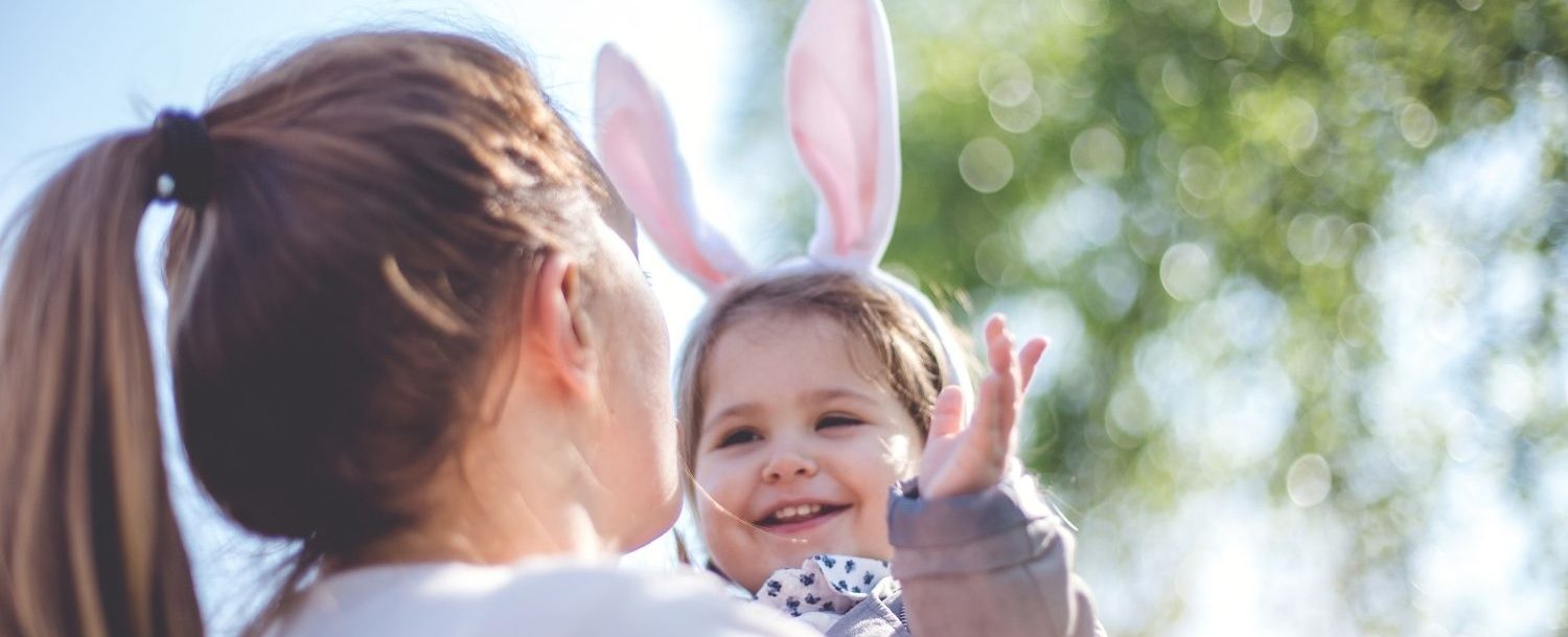 Mom holding a baby wearing easter bunny ears