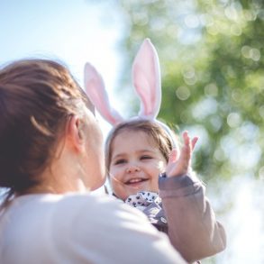 Mom holding a baby wearing easter bunny ears