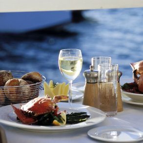 Table of food near the water. Waterfront dining.