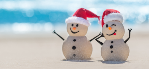 snowmen with Santa hats on beach