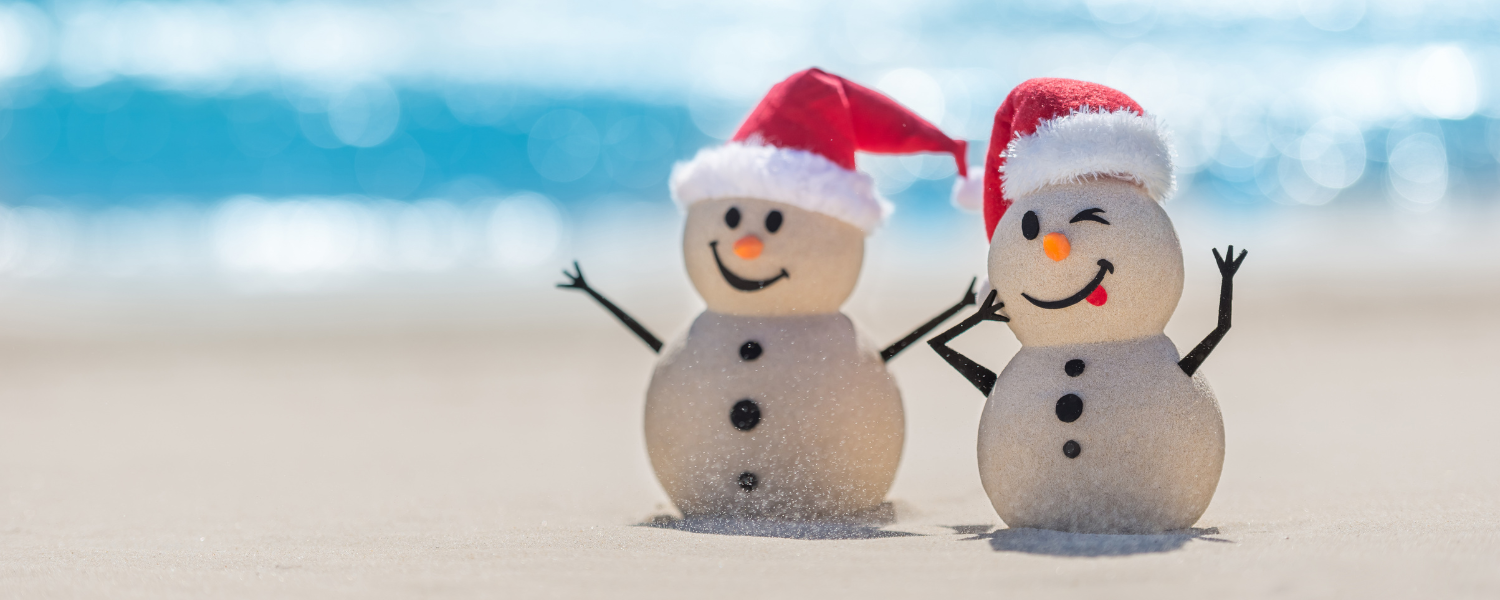 snowmen with Santa hats on beach