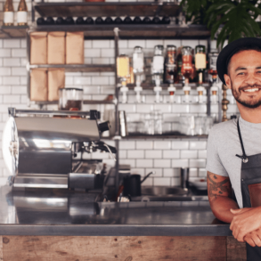 Barista behind counter of coffee shop