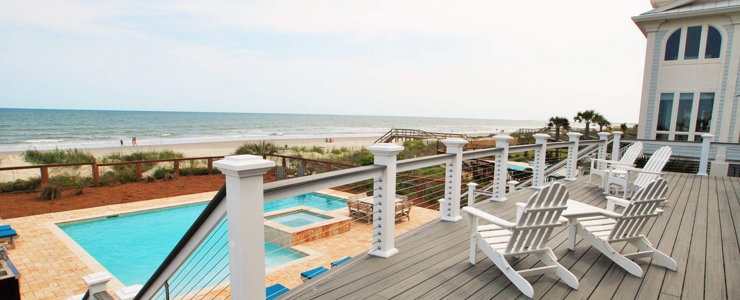   East Islands Rentals - porch overlooking a pool and the ocean