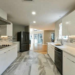 Inside of vacation rental's kitchen with tiled floors and backsplash