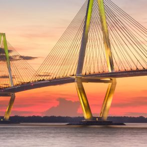 A picture of the Ravenel bridge at night connecting IOP to mainland Charleston