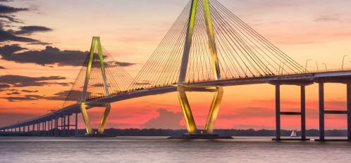 A picture of the Ravenel bridge at night connecting IOP to mainland Charleston