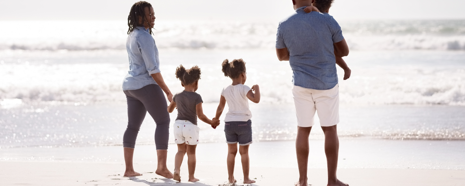 african american family with small children on beach