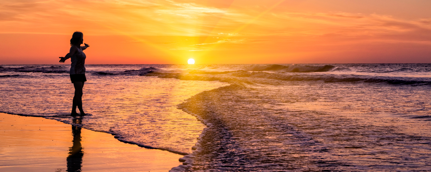 woman on beach at sunrise