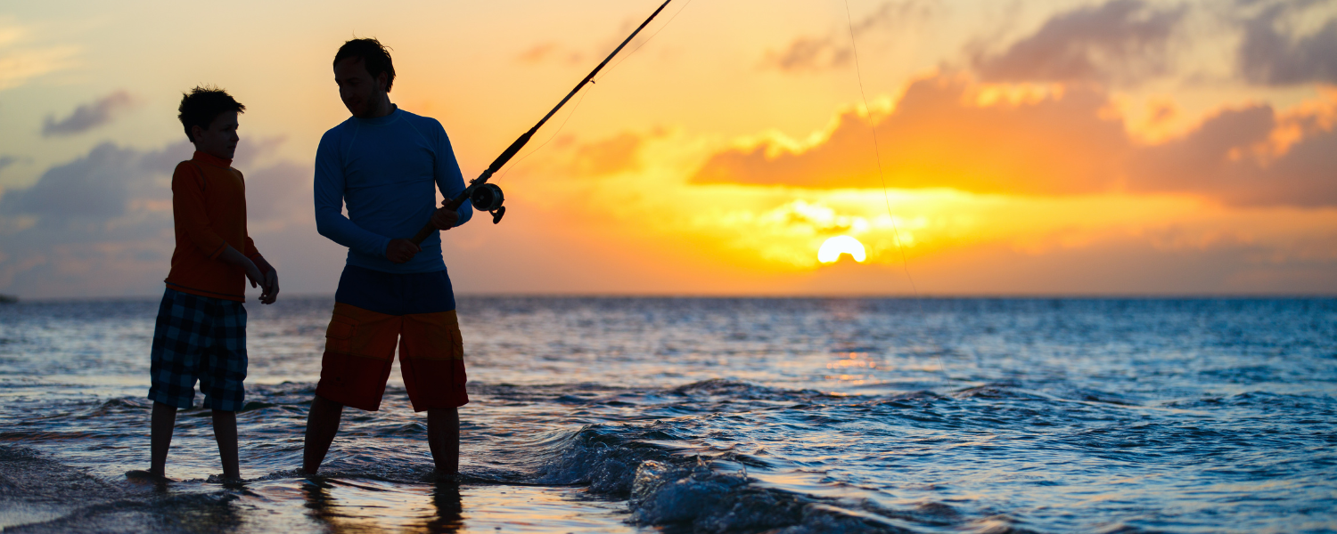 boy and man surf fishing