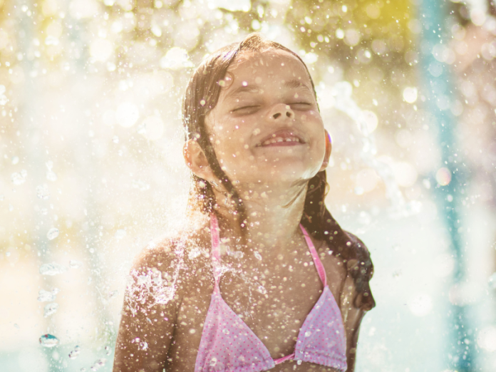 young girl playing in water