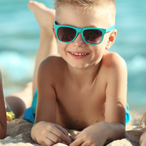 three kids on beach with sunglasses