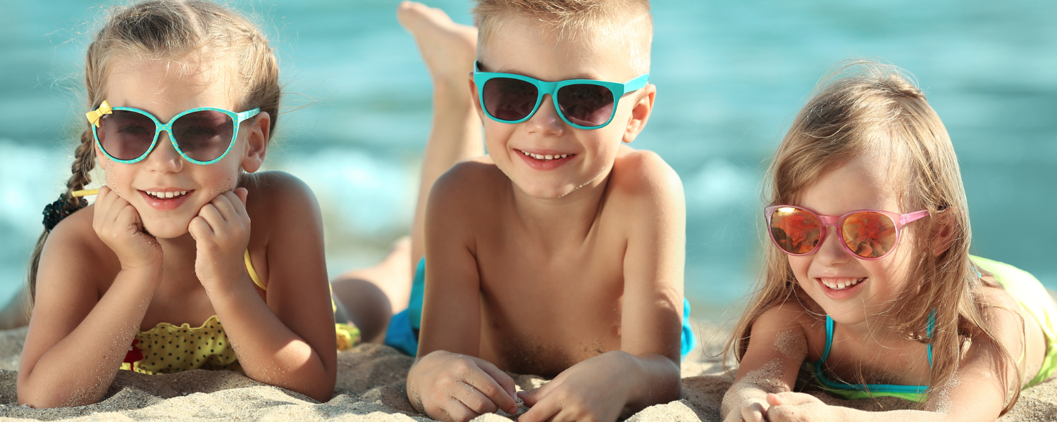 three kids on beach with sunglasses