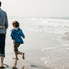 family of four walking on the beach