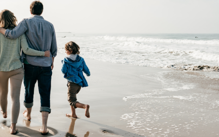 family of four walking on the beach
