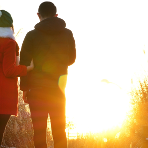 couple overlooking sunrise in winter
