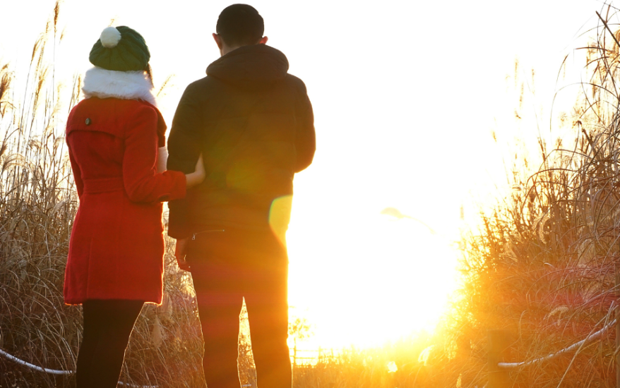 couple overlooking sunrise in winter