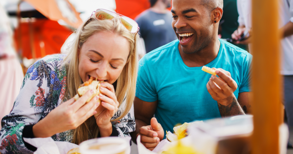man and woman eating outdoors