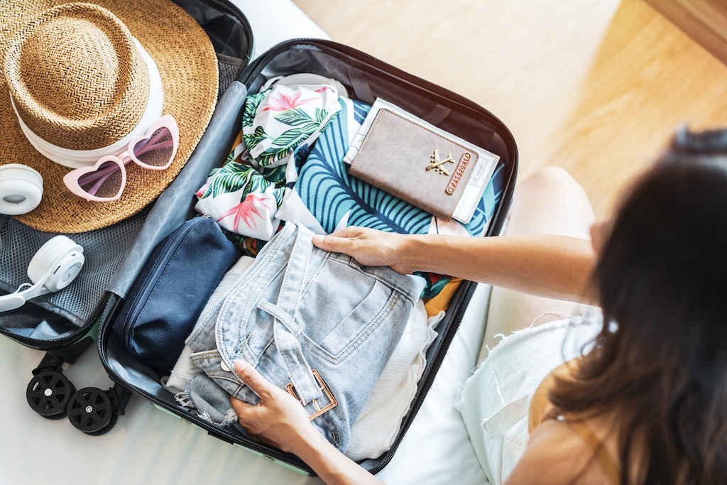 A woman packing for vacation.