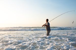 A man Surf Fishing in the ocean. 