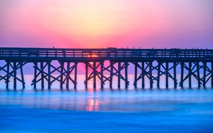 Sunrise over the pier at Isle of Palms, SC, USA.